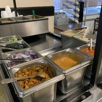 Sauce, condiments and soup station. at Taj Chaat House in Irving