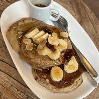 Fluffy Pancake - Banana & cinnamon pancake topped with banana, date, almond, maple on the side  at Kayu Cafe in 