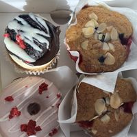 Two blueberry and almond muffins, a white chocolate and raspberry doughnut and a vanilla cupcake with chocolate extravagance on top. ALL GLUTEN FREE + VEGAN 🌟   at Ruby's of London in South East London