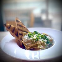 Jerusalem artichoke, garlic and black truffle ravioli, swimming in a dairy-free white wine and chive beurre blanc with griddle toasted sourdough.   at Cafe Needles Eye in Newbiggin-by-the-sea