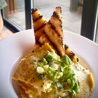 Jerusalem artichoke, garlic and black truffle ravioli, swimming in a dairy-free white wine and chive beurre blanc with griddle toasted sourdough.   at Cafe Needles Eye in Newbiggin-by-the-sea