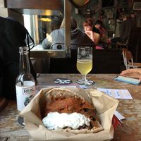 Amazing spicy coated seitan wholemeal pita with loads of veggies and tzatzikiiii💚 at Beelzebab in Brighton