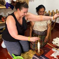 Travelers learning from Indigenous weavers in Lake Atitlan at Unruly Travel Group Trips - Asheville in Asheville