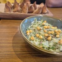 Samosa and salad at Pūrnah: Kitchen. Pantry. Table in Mumbai