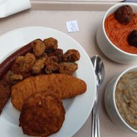 Mix of everything left plate. Lentil stew and kofta with millet both small on the right at Vega City in Budapest