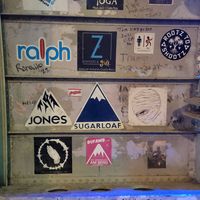 Weak food but Cool atmosphere: Inside of the plane adorned with stickers of the world (including Maine's Sugarloaf) at El Avion in Manuel Antonio