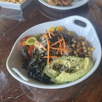 Vegana Poke Bowl and Vegetarian Fajitas (with no sour cream and a side of fries) in the background! Both very fresh and tasty!   at El Avion in Manuel Antonio