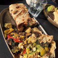 Delicious grilled vegetable, hummus and avocado roti- amazing.   at Manu's Cafe and Restaurant in St Kilda