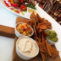 Vegan raw nachos with salsa, cashew nut cream cheeze, mushroom and walnut meat & raw kebabs  at Tanya's Cafe in South West London