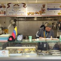 Juan serving another happy customer at Arepita in Derby