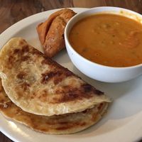 Curry with roti and samosa at Mantra Lounge in Carlton