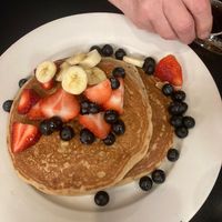 Pancake stack eith fresh fruit and maple syrup on the side at Fuel Cafe in Hicksville