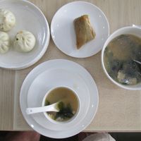 A selection (steamed savoury buns, peppery soup and steamed rice with sweet filling) from the breakfast menu at PUREST素食餐厅 (Purest Canting) in Vientiane