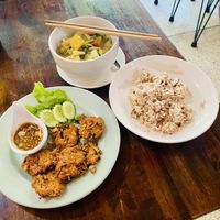 Flower blossoms with a sweet and spicy peanut sauce, massaman curry and rice  at May Kaidee Chiang Mai in Chiang Mai