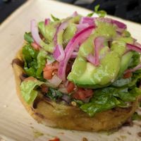 Sopes La Maria! Thick corn tortilla cups, no cheese/crema, refried/black beans, avocado, pico de gallo, & lettuce. Ask for hot sauce & pickled onions to maximize flavor!  at Manolete's Cocina Gourmet in Winchester