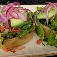 Sopes La Maria! Thick corn tortilla cups, no cheese/crema, refried/black beans, avocado, pico de gallo, & lettuce. Ask for hot sauce & pickled onions to maximize flavor!  at Manolete's Cocina Gourmet in Winchester