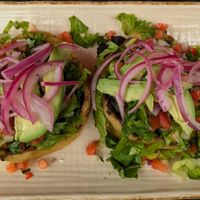 Sopes La Maria! Thick corn tortilla cups, no cheese/crema, refried/black beans, avocado, pico de gallo, & lettuce. Ask for hot sauce & pickled onions to maximize flavor!  at Manolete's Cocina Gourmet in Winchester