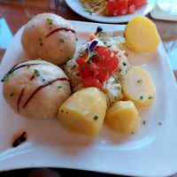 Vegan "Fleischknödel" are homemade "meatballs" (potato dough filled with pea protein) with cabbage, potatoes and tomatoes at Mostheuriger Pihringer in Winklarn