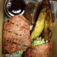 Jerk Tofu Wrap with potatoe wedges, BBQ dipping sauce, & extra jerk sauce at Karyn's Cooked in Chicago