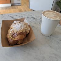 Almond and choc croissant (still warm!) hot choc. Disposable cups only bring your own reusable one at Take a Bite and Smile – Artisan Bakery & Café in South West London