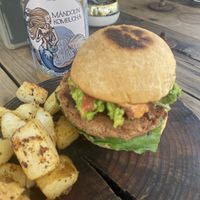 Veganator Burger w/Potatoes & Fresca-Kiwi Kombucha  at Verde Vegan in Acapulco