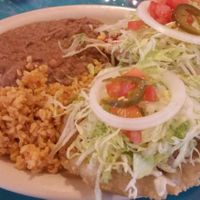Vegan Puffy Tacos lunch special. 2 tofu puffy tacos with 2 sides (brown rice and pinto beans). $7.45 includes iced tea or coffee at La Fiesta Patio Cafe in Universal City