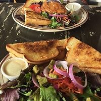 Warlock Sandwhich with side salad (near) crispy chicken salad (far) at The Wayward Cafe in Seattle