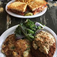 chicken parm in the back and country fried 'steak' in the front with potato cakes   at The Wayward Cafe in Seattle