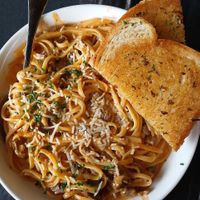 Pasta bolognese with garlic bread at The Wayward Vegan in Seattle