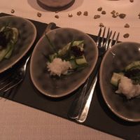 appetiser with sliced cucumber, sushi rice, sea asparagus, seaweed powder and soy sauce caviar at TIAN Munich in Munich