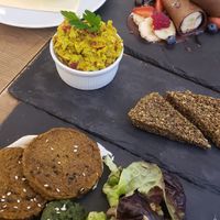 Pea soup, sweet pancakes (rolls), tofu/avocado "scrambled eggs", sweet potato patties at MyRaw Cafe in Prague