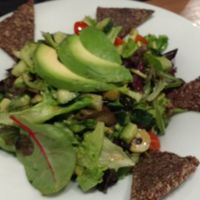 Salad with avocado and crakers at MyRaw Cafe in Prague