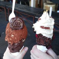 Caramel ice cream coated in toasted coconut in a chocolate almond cone (left). Chamomile feijoa ice cream in a coco nib and plum cone with pecans. at Giapo in Auckland