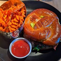 Veggie burger with pretzel bun and sweet potato fries at DEN - Root Down - TC in Denver