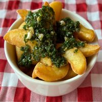 Potato wedges with garlic and chive dressing  at Palm Kitchen - Restaurant in Dubai