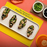 Mexican Bruschetta at Hoggeterians – Crispy toasted bread topped with fresh veggies, zesty Mexican flavors, and vibrant seasonings for the perfect fusion appetizer. at Hoggeterians - Fusion Restaurant in Gujarat