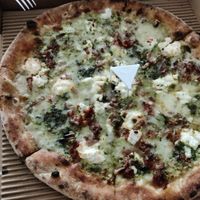 Whole wheat base, double basil pesto, red pesto, vegan mozzarella (just because), goat cheese, blue cheese (gorgonzola), parmesan, ricotta, pine nuts. Best pizza ever! at Pizza Di Rocco in Abu Dhabi