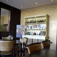 little cupboard filled with cook books and Italian spices and oils at Pizza Di Rocco in Abu Dhabi