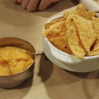 Nachos with carrot cheese dip at Dolce Pizza y Los Veganos - Hipolit Lazaro in Barcelona