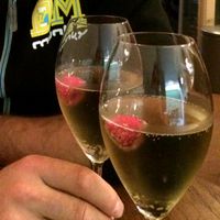 Lavender-infused sparkling wine with a raspberry at Bites and Wines in Antwerpen