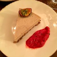 Lavender cheesecake with raspberry coulis and a passionfruit garnish at Bites and Wines in Antwerpen