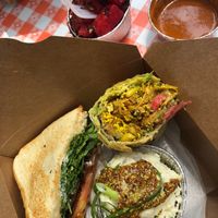 Tempeh sandwich, jackfruit wrap, potato salad, watermelon salad. at Dharma Southern Chick'n in Orlando