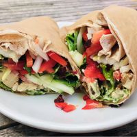 Yogi wrap with hummus red peppers onion cucumbers tomato & cranberries. at Green Cup Cafe in Fort Myers