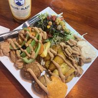 vegan mix bowl with plantain, tofu seitan, and falafel. topped with spicy peanut sauce and paired with sumac dusted fresh salad   at Kilimanjaro Wraps & Bowls in Berlin