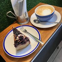 Vegan cheese cake with blueberry and flat white with oat milk  at KIRAS - Totoriu 7 in Vilnius
