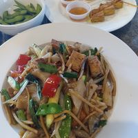 Drunken man noodles with fried tofu. Back: edamame and tofu satay. at Thai Meal in Plantation