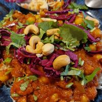 Red curry with rice, chickpeas, cashew nuts, and coriander at Roots Kitchen in Turku