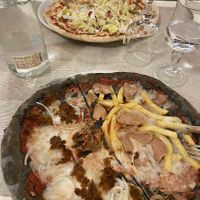 Mine was Half vegan tuna/half würstel and chips, other pizza was vegan kebab  at Il Papiro in Milan