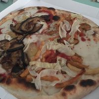 Half parmigiana - half kebab pizza at Il Papiro in Milan