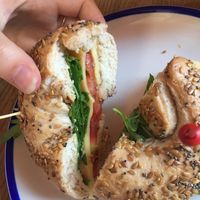 Flax chia bagel with vegan cheese, tempeh, tomato, rocket  at Flax & Kale - Placa Castella in Barcelona